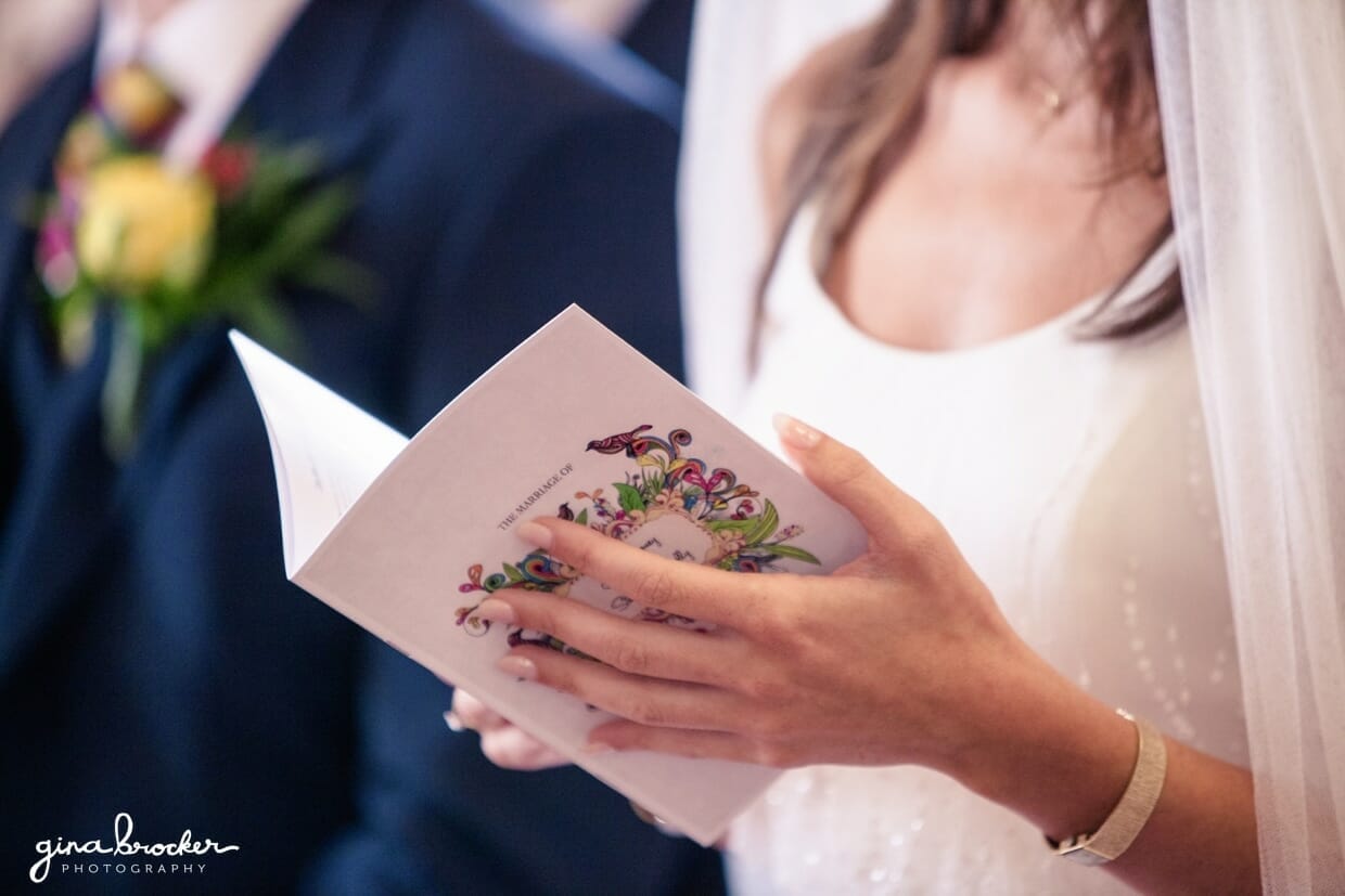A detail of the bride holding a colorful and beautifully designed wedding program