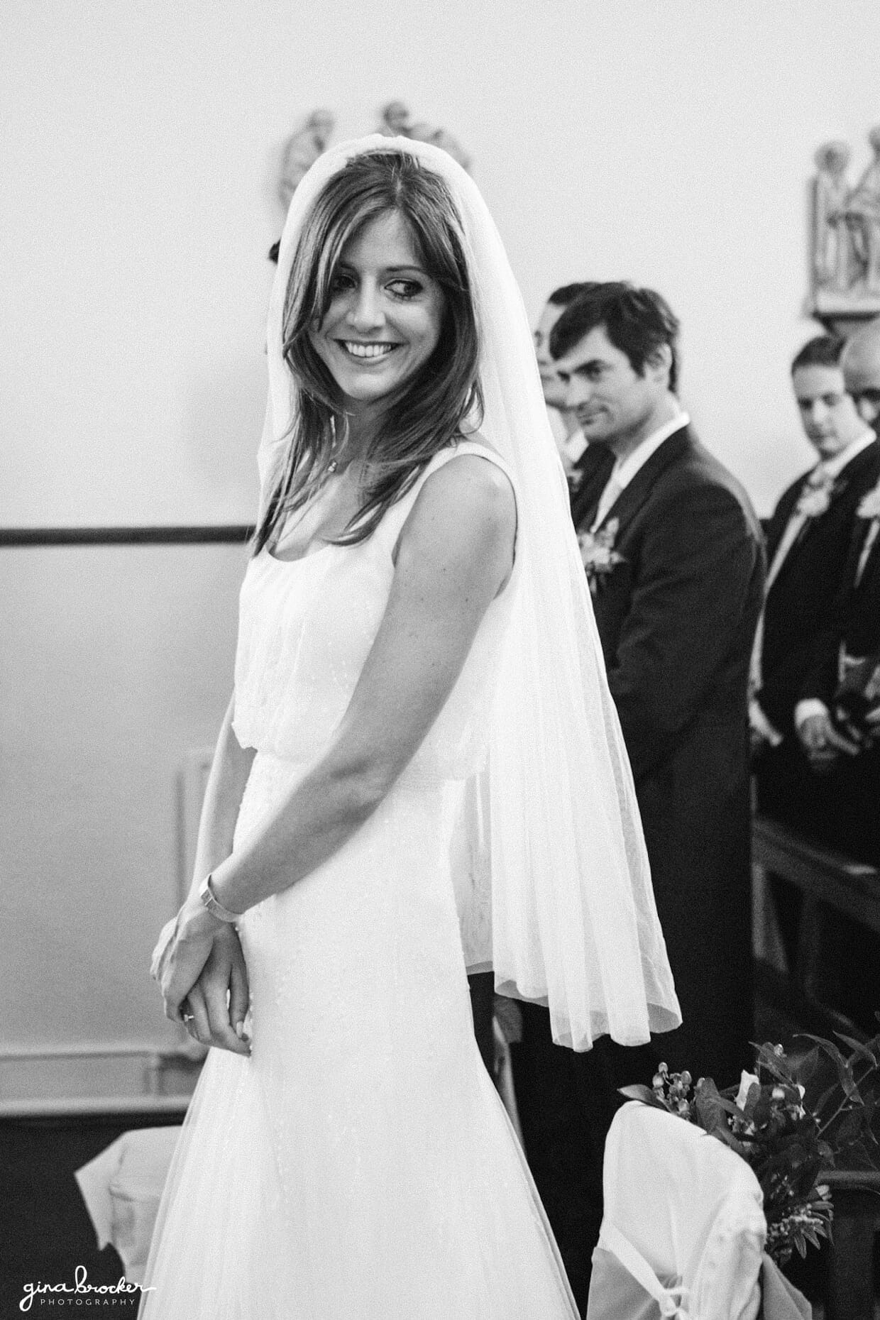 The bride smiles at her parents during her intimate wedding ceremony in a small church