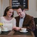A couple share a sweet moment in a Beacon Hill Cafe during their anniversary photography session