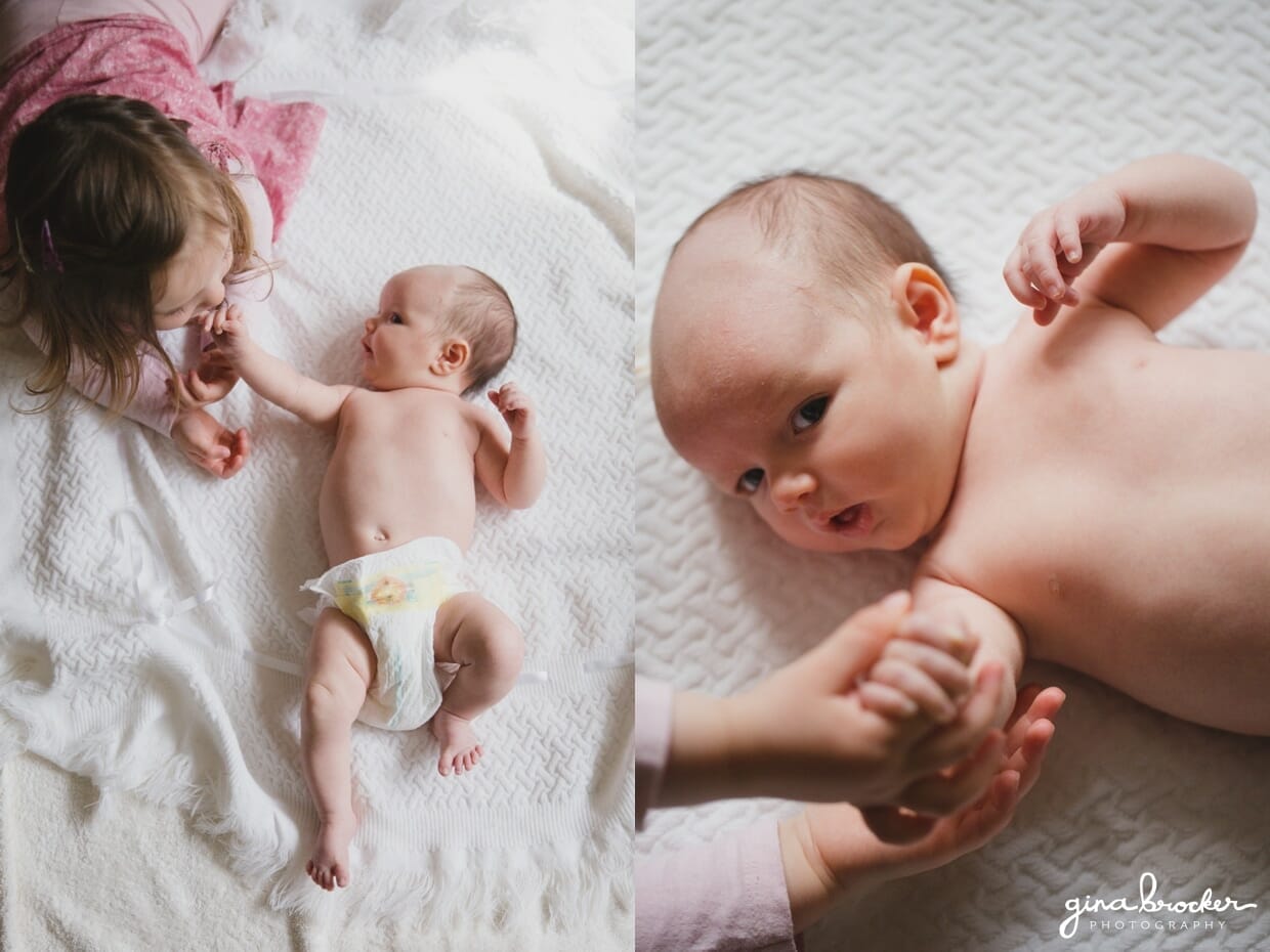 A little girl lays beside her baby sister during a boston family photo session at home