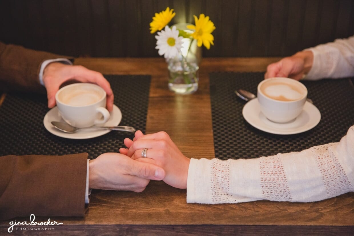 A detailed photograph of a couple holding hands at a beacon hill cafe during a boston couple session