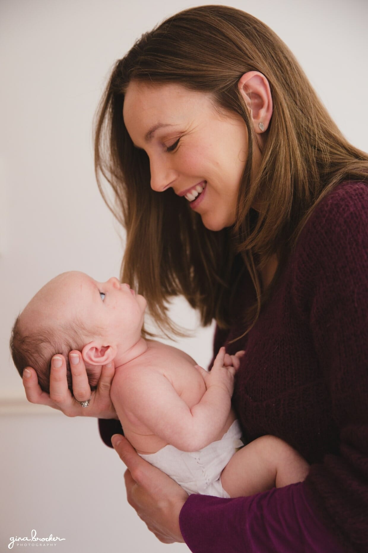 Mom holding baby during a family photo session at home in Boston, Massachusetts
