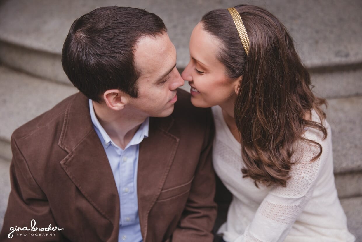 A sweet portrait of a couple as they sit on the steps of their beacon hill home during a boston engagement session