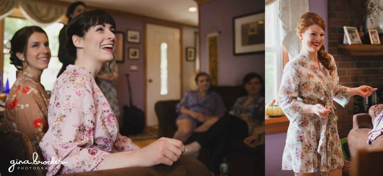 Bridesmaids wearing floral robes laugh together on the morning of a Massachusetts wedding