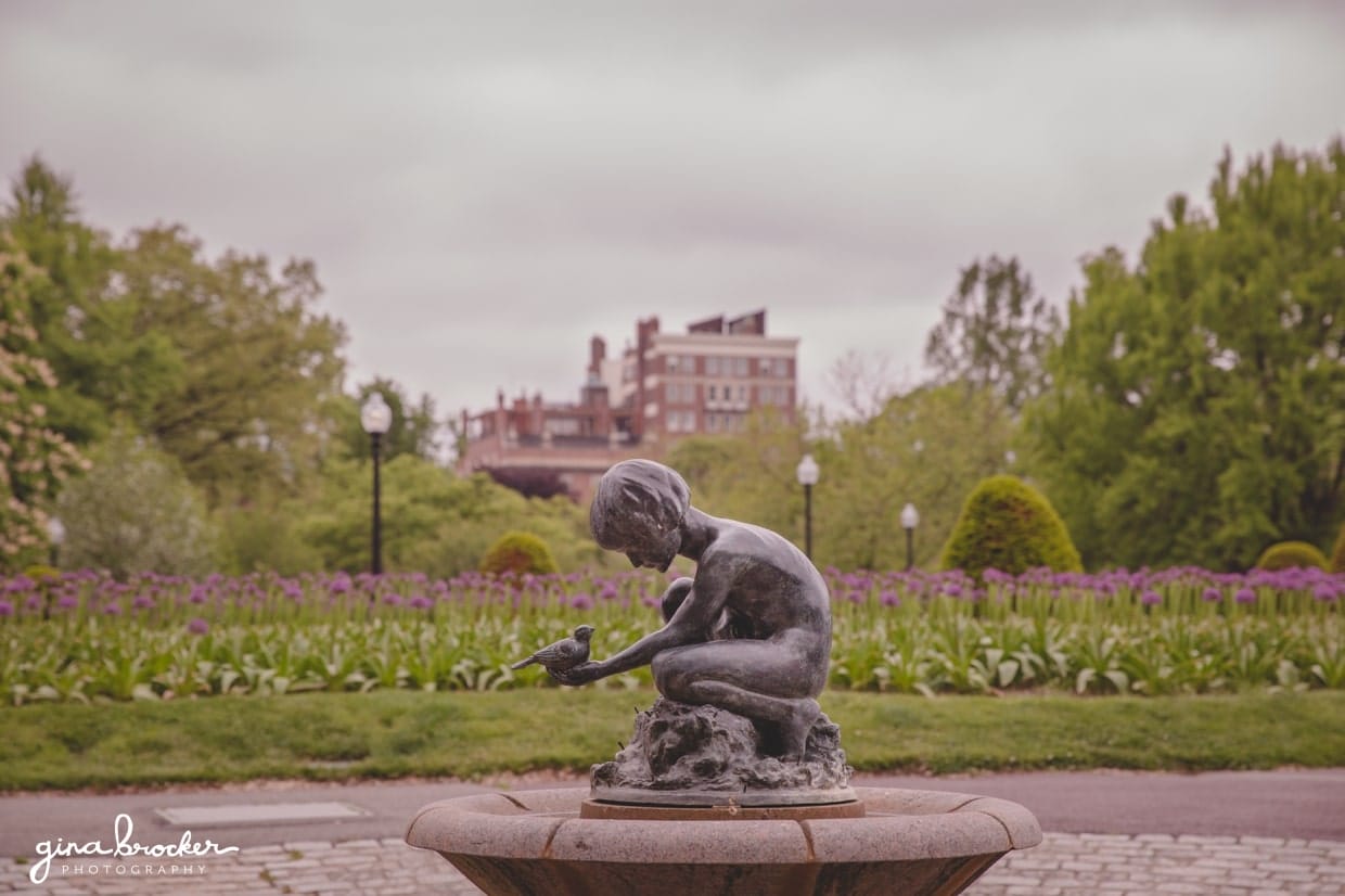 A beautiful statue of a girl holding a bird in the Boston Public Gardens