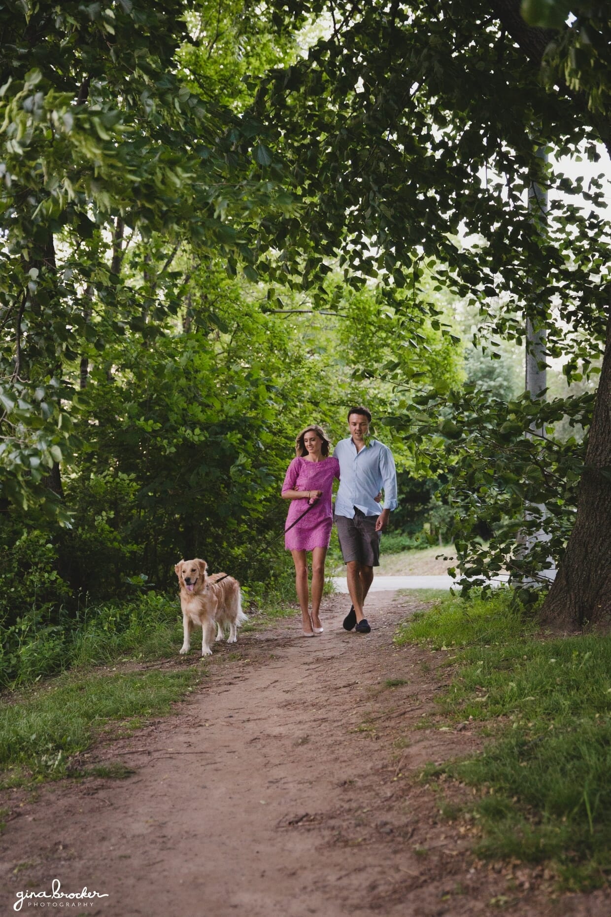 A couple walk their dog during their springtime engagement session at prospect park in brooklyn, new york