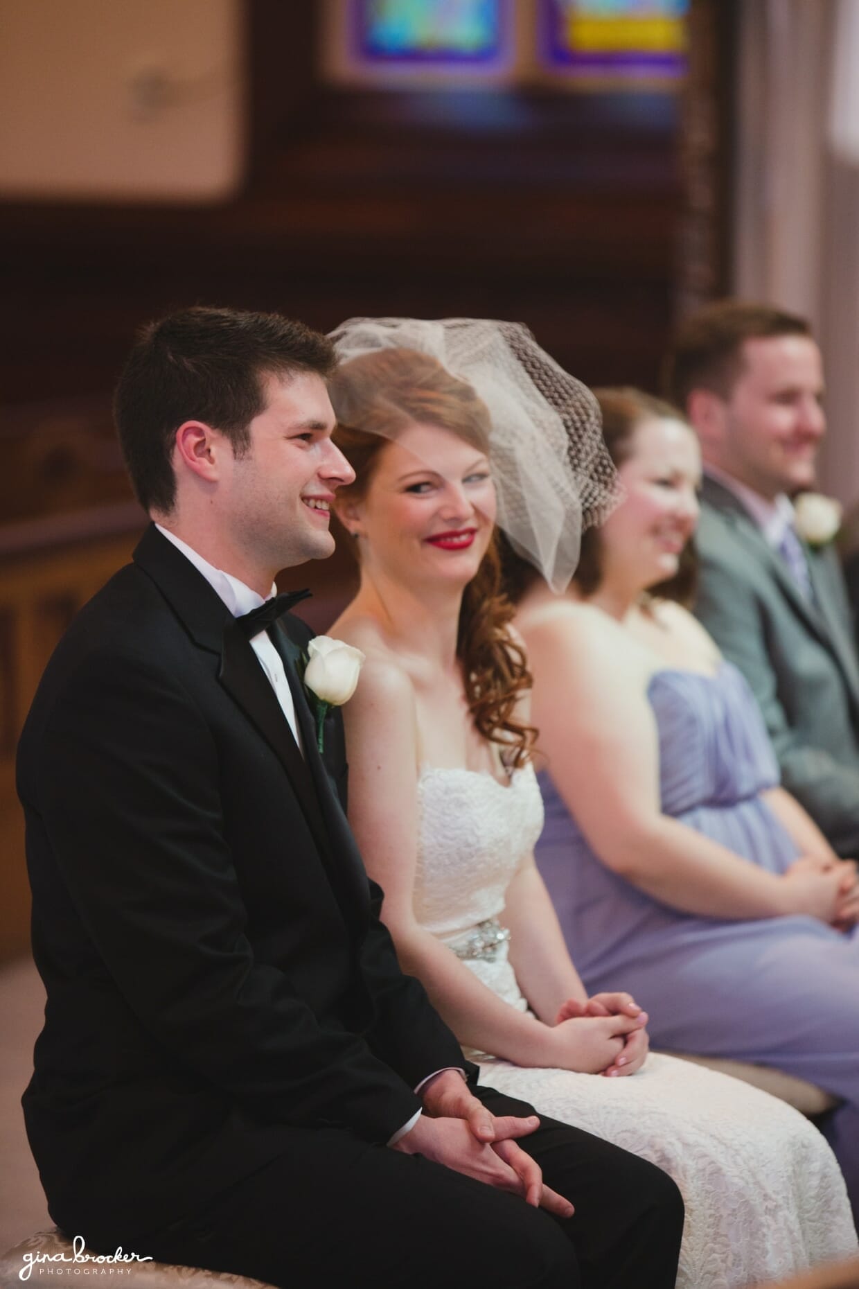 A bride smiles at her groom during their wedding ceremony at the Sacred Heart of Jesus Church in Cambridge, Massachusetts