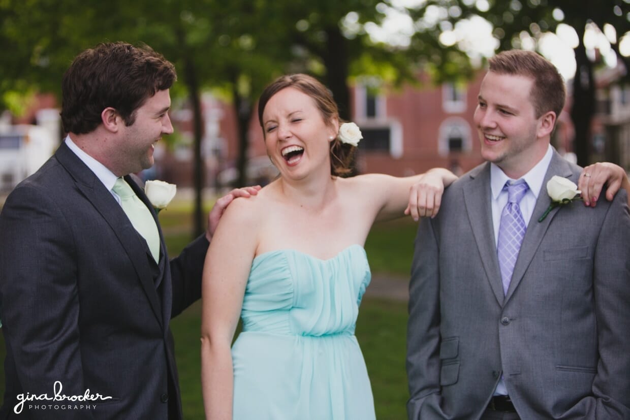 A candid photograph of a bridesmaid and groomsmen during a wedding reception in Salem Common