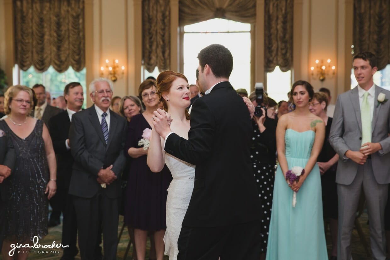 A bride looks into her grooms eyes during their first dance at the Hawthorne Hotel in Salem, Massachusetts
