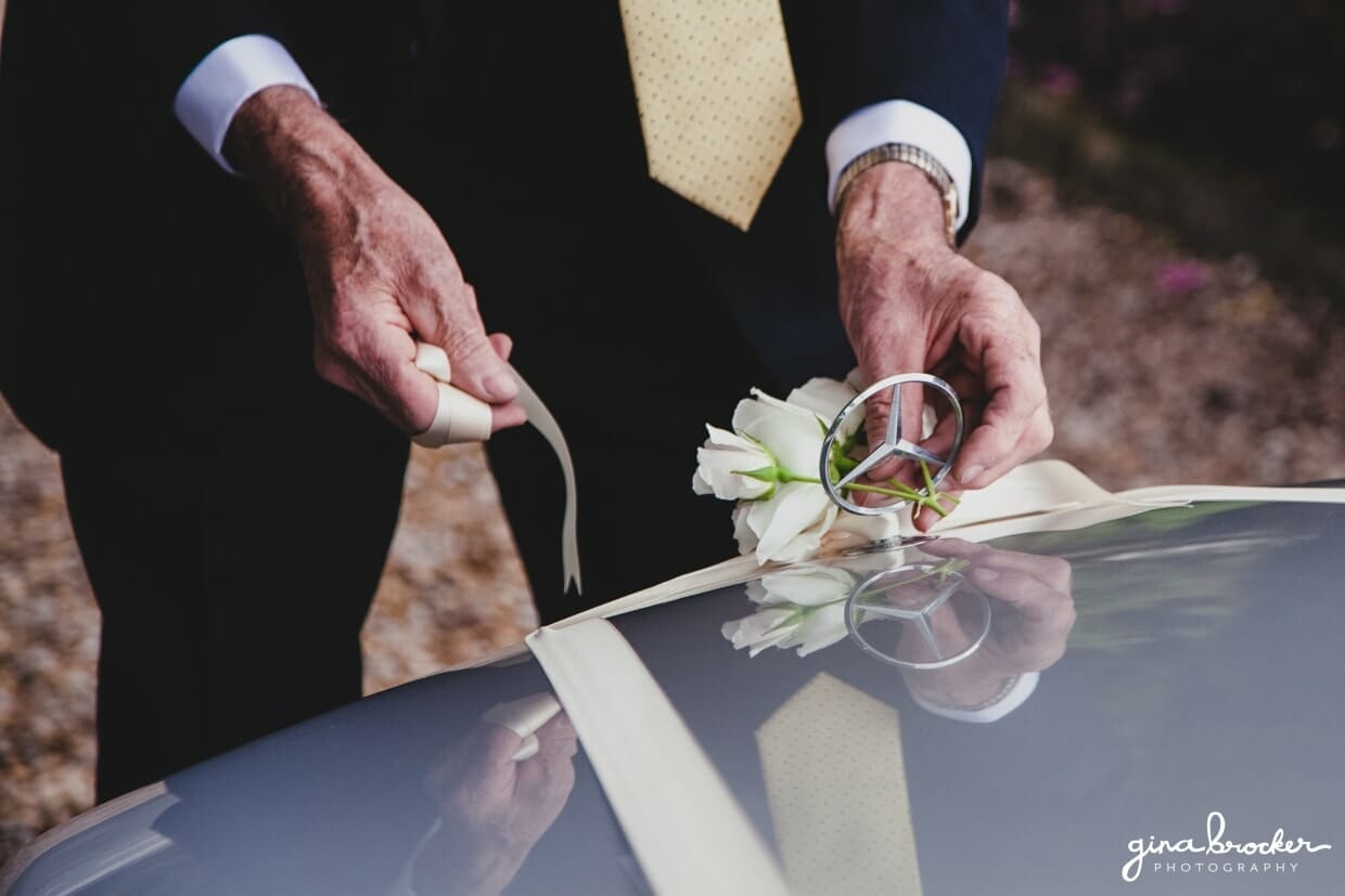 A flower is fastened to a silver wedding car on the morning of a Boston wedding