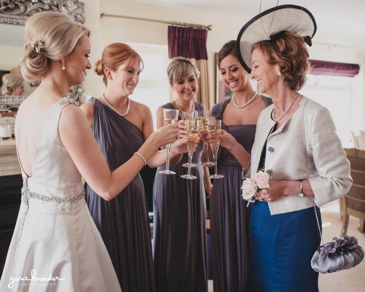 A bride shares a champagne toast with her bridesmaids and mother on the morning of her classic garden wedding