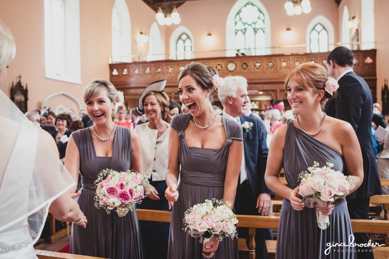 Bridesmaids congratulate the bride by shaking her hand during her wedding ceremony in Boston, Massachusetts