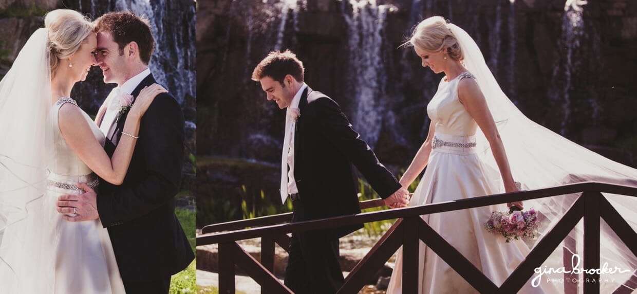 A portrait of the bride and groom near a waterfall during their classic garden wedding