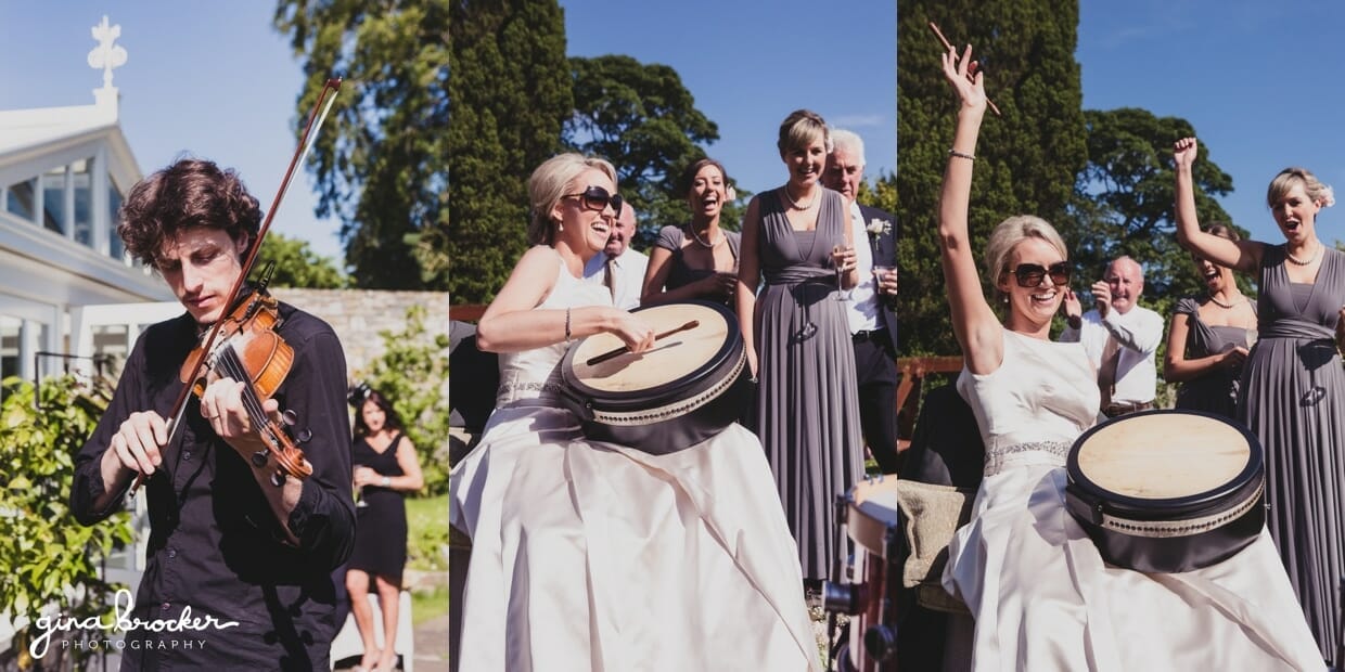 Candid photograph of a bride playing music with the band during her garden themed wedding outside of Boston, Massachusetts
