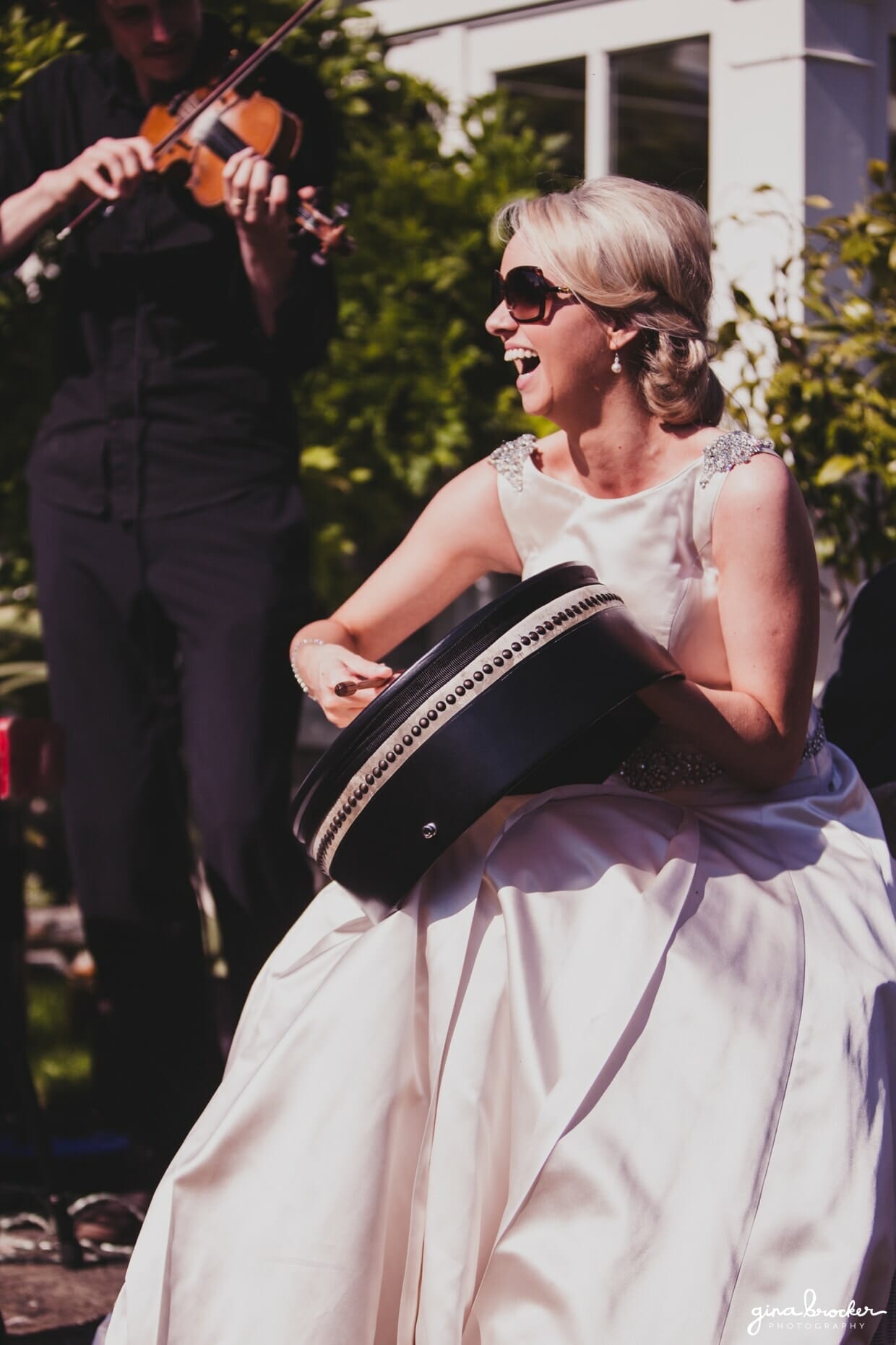 Candid portrait of a bride playing with the band during her classic garden wedding