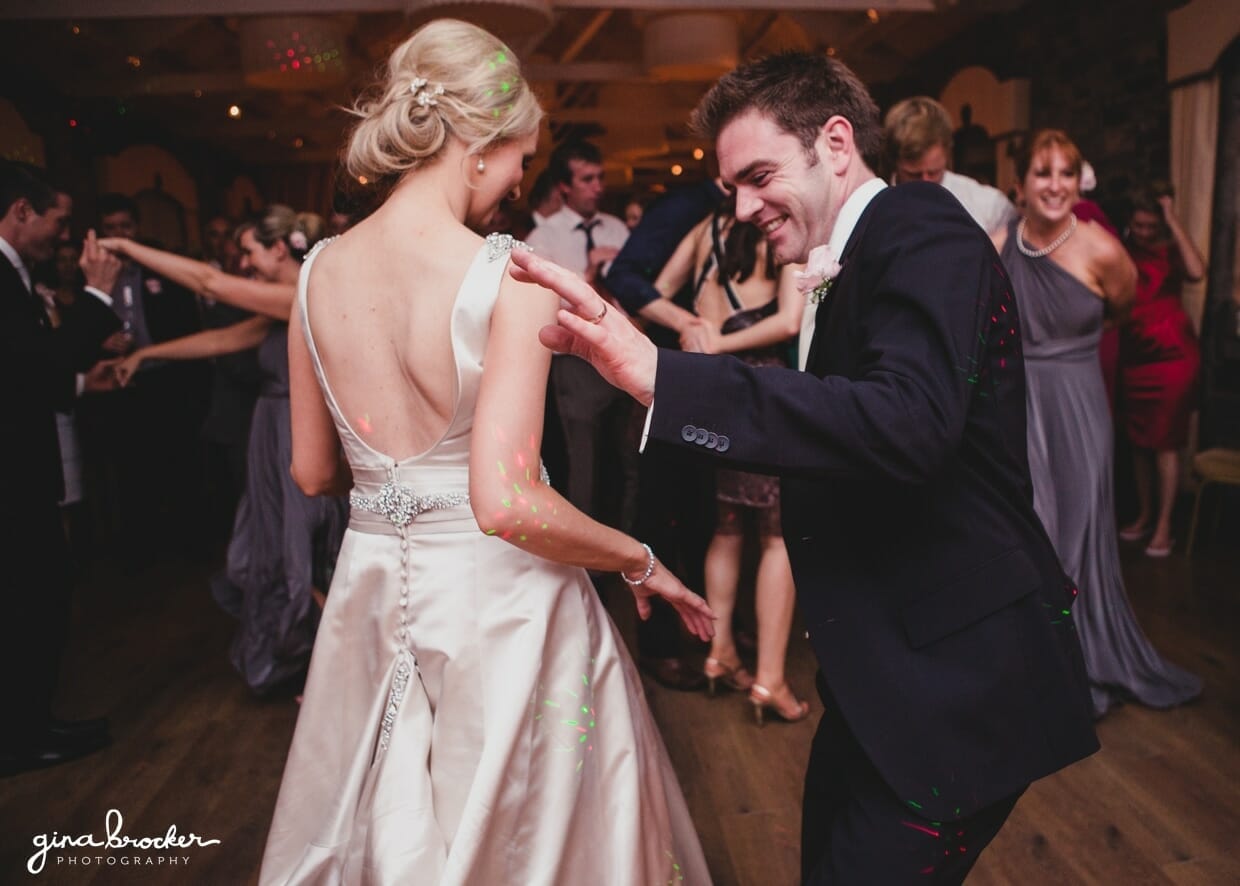 The bride and groom dance with their guest during the classic garden wedding reception