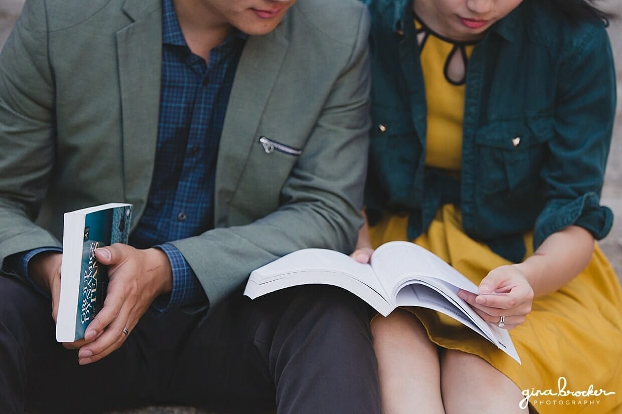 A close up photograph of a couple reading books together at Northeastern University during their Boston Engagement Session