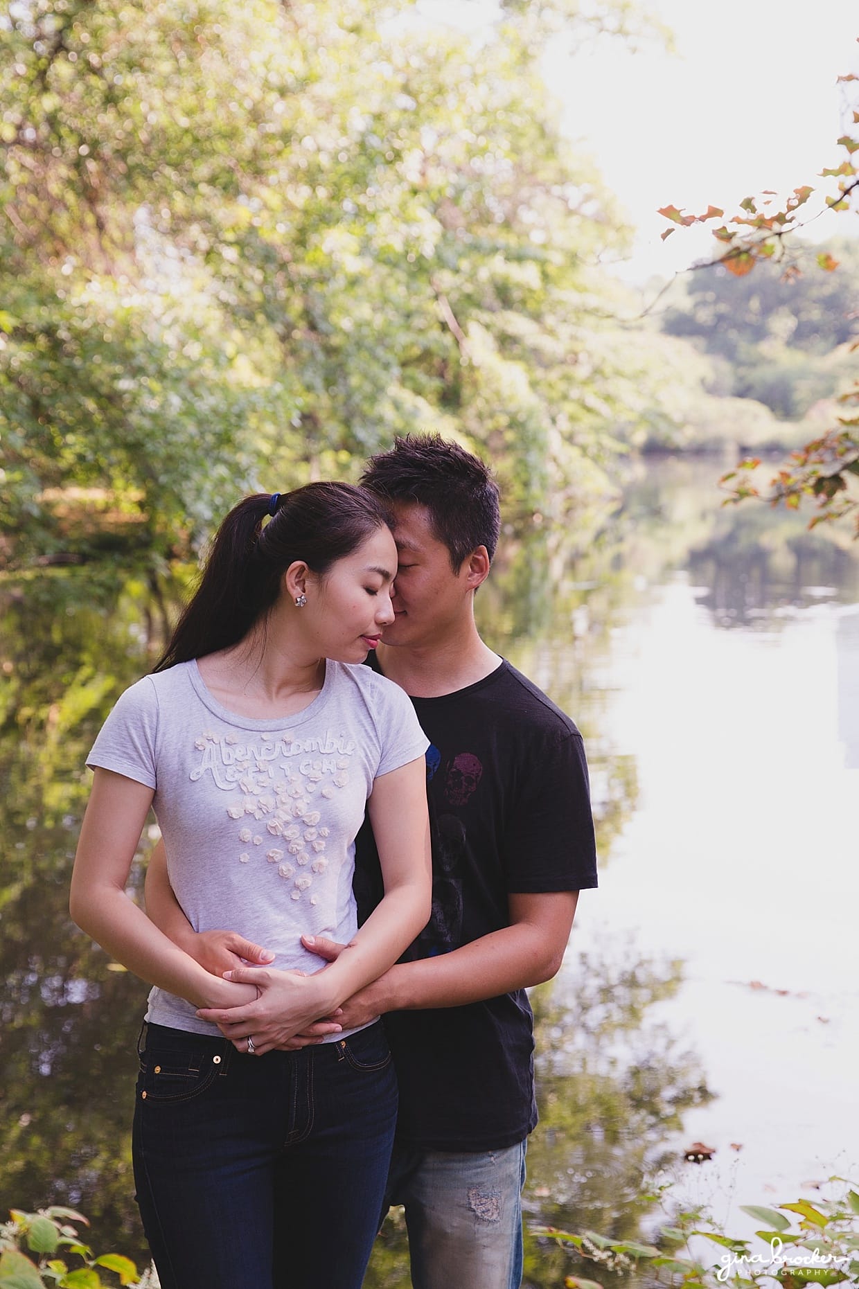 A sweet portrait of a couple holding one another during their Boston engagement session in back bay fens park