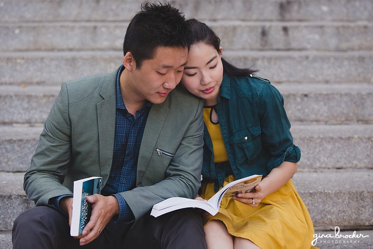 A sweet photograph of a couple reading books on the steps of Northeastern University during their engagement session in Boston, Massachusetts
