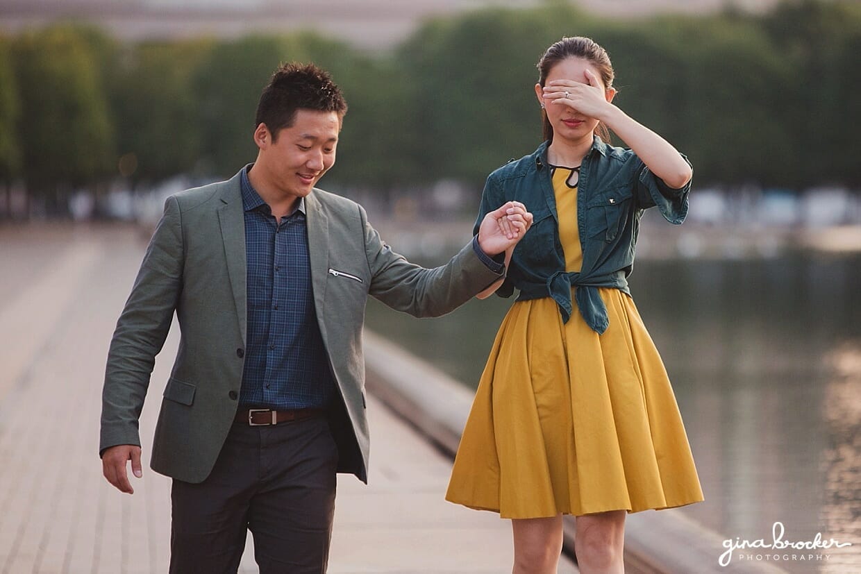 A man leads his fiancé to a secret surprise during their Boston Engagement Session at the Christian Science Center