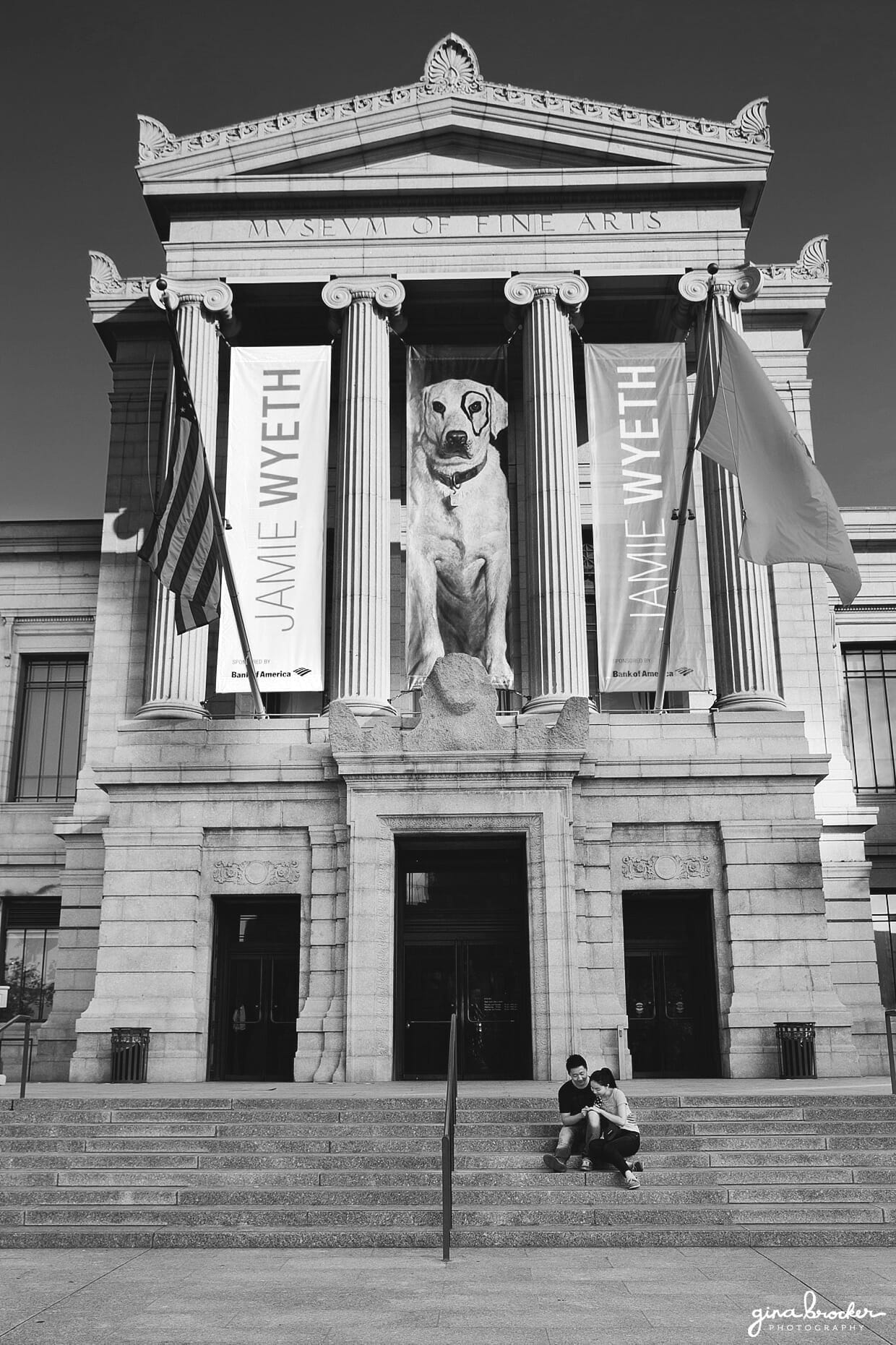 A couple sit on the steps of Boston Museum of Fine Art during their engagement session in the city