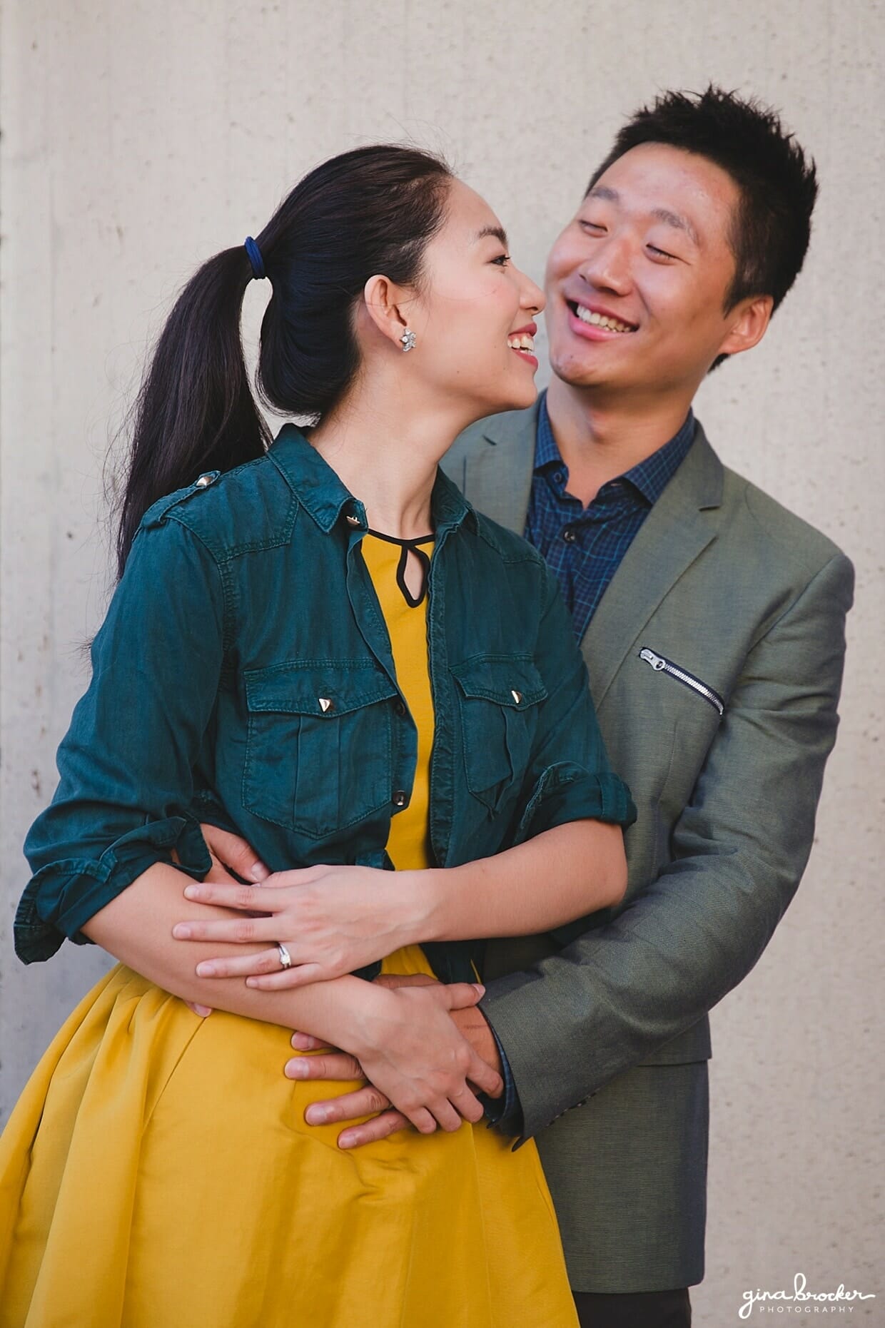 A fun portrait of a couple laughing together during their Boston Engagement Session at the Christian Science Center