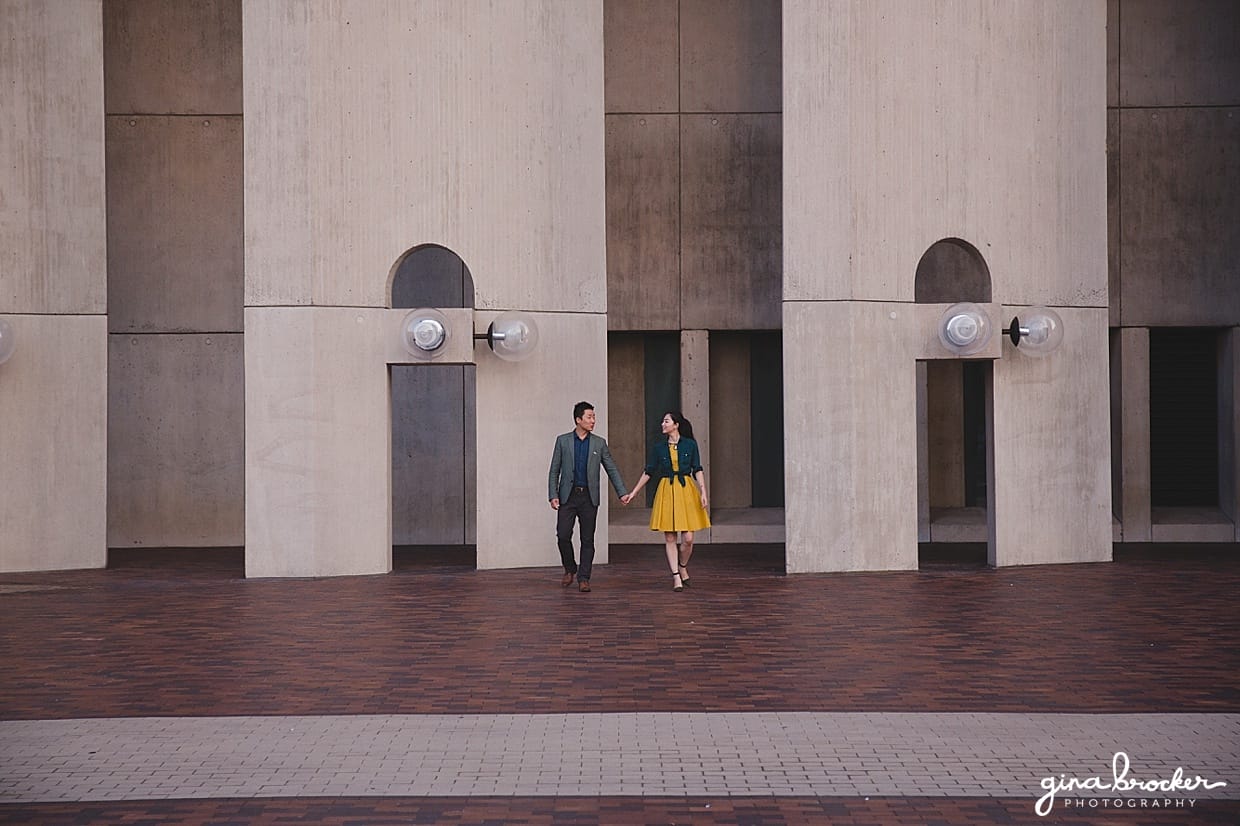 A couple walk hand and hand during their engagement session at the Christian Science Center in Boston, Massachusetts