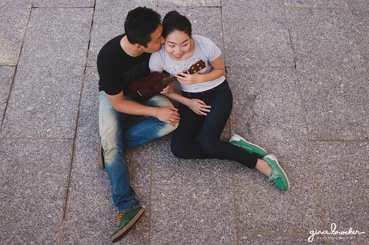 A cute photograph of a couple playing music during their Boston engagement session
