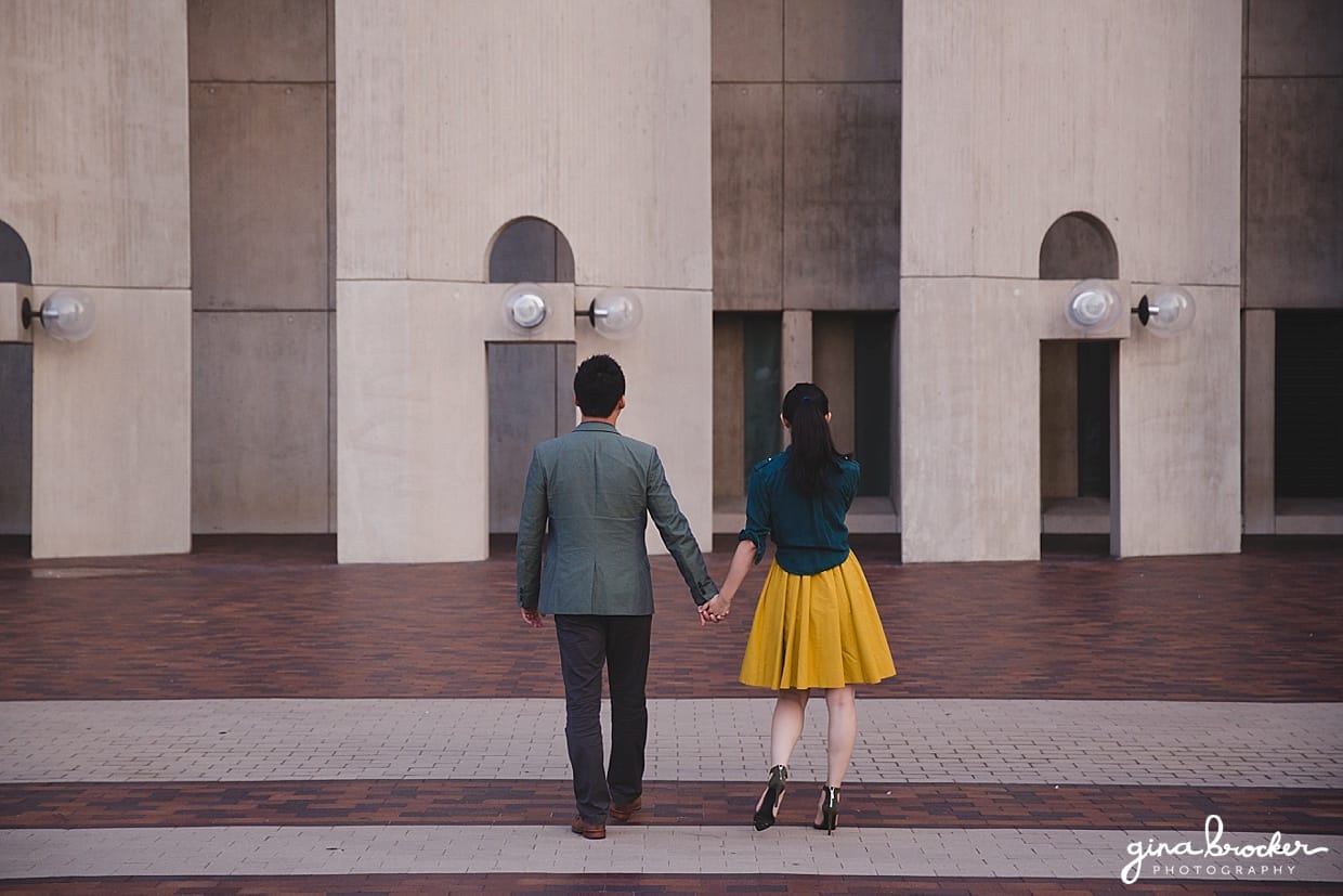A portrait of a couple walking away during their Boston Engagement Session at the Christian Science Center