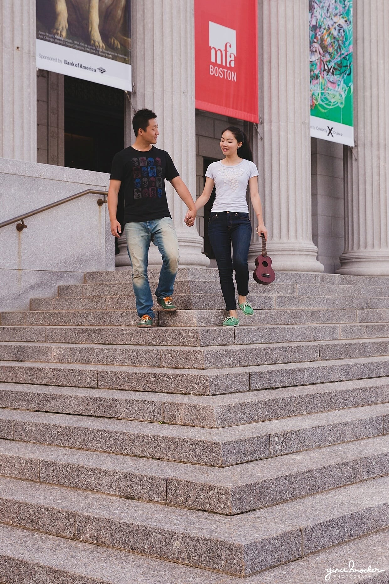 A couple walk down the steps of the Boston Museum of Fine Art during their engagement session