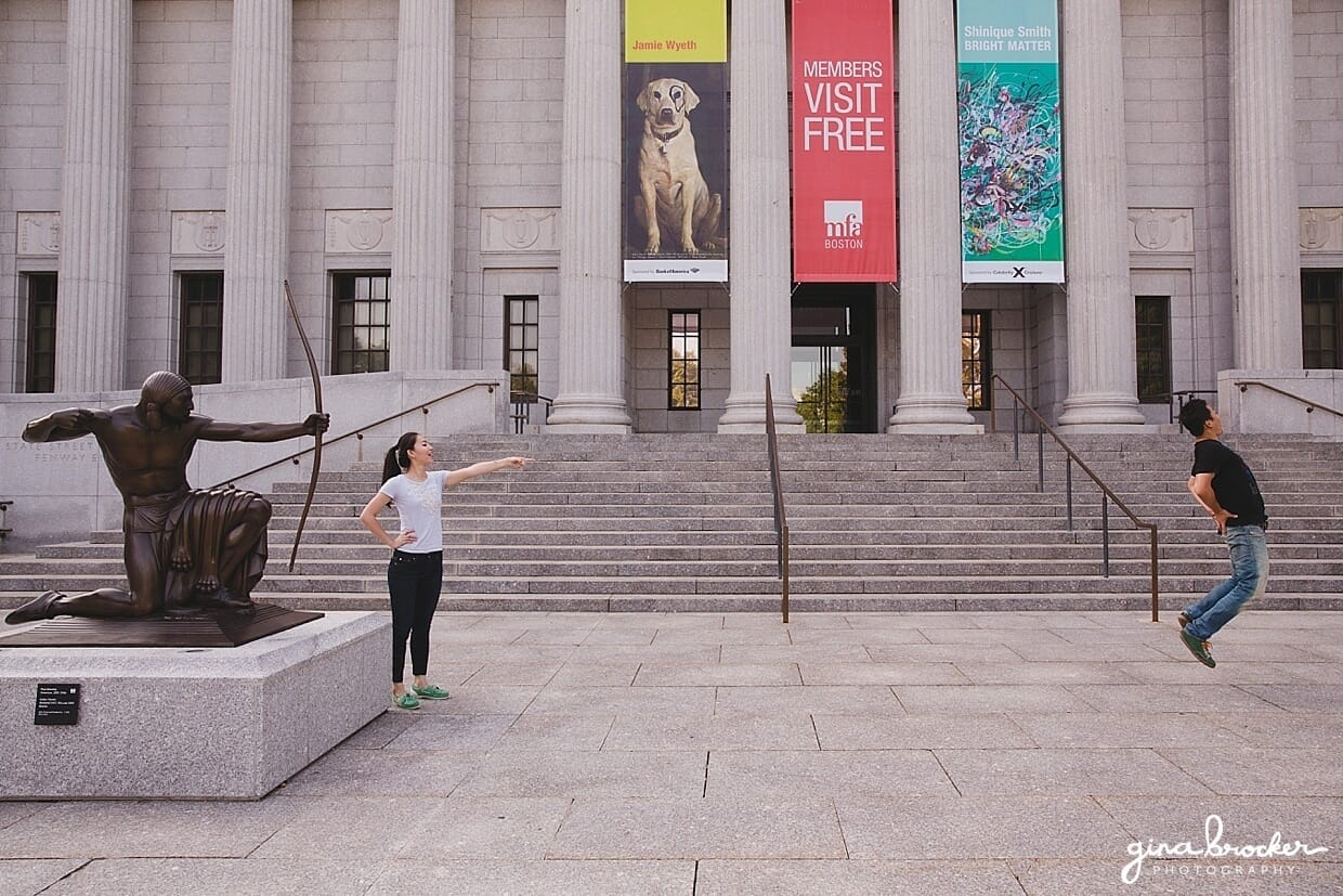 A fun photograph of a couple during their engagement at the Boston Museum of Fine Art