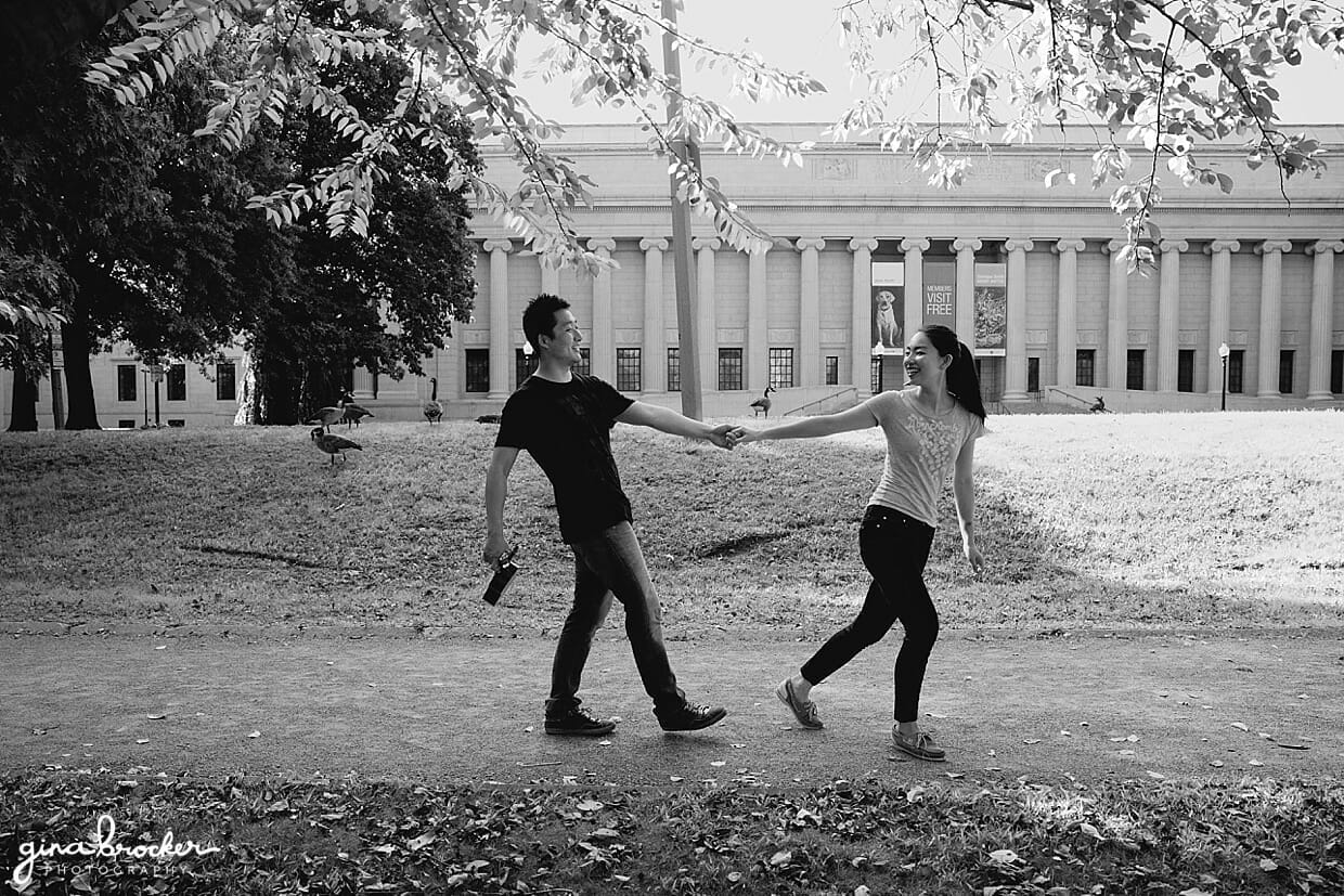 A cute photograph of walking hand in hand during their engagement session at the Boston Museum of Fine Art