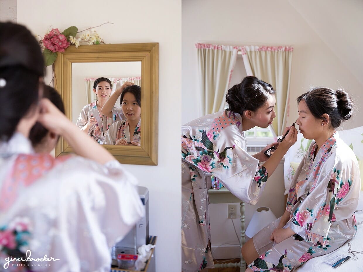 A bride and her bridesmaid get ready in matching dressing gowns on the morning of their hammond castle wedding