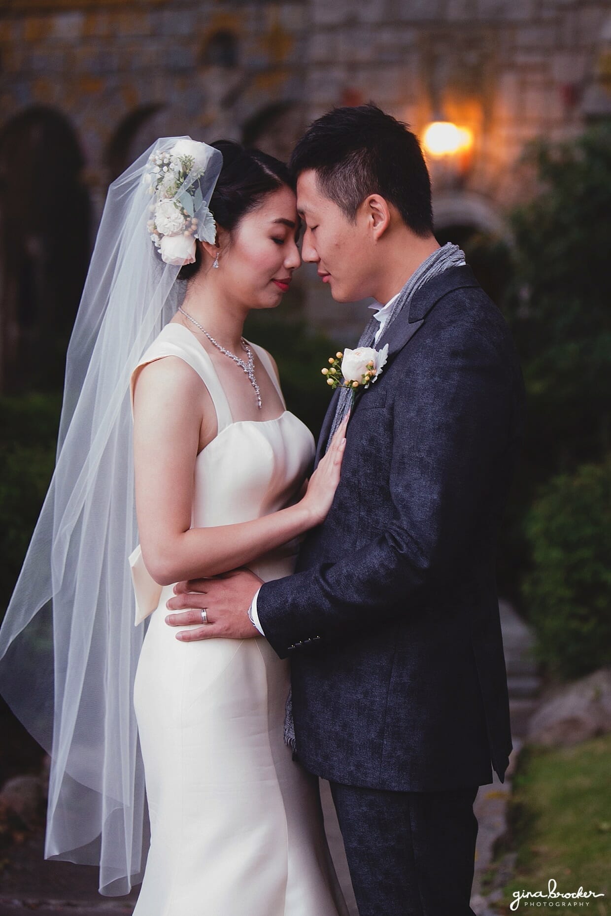 A sunset portrait session of a bride and groom wearing an Amsale wedding dress and John Varvatos suit during their hammond castle wedding in Gloucester, Massachusetts