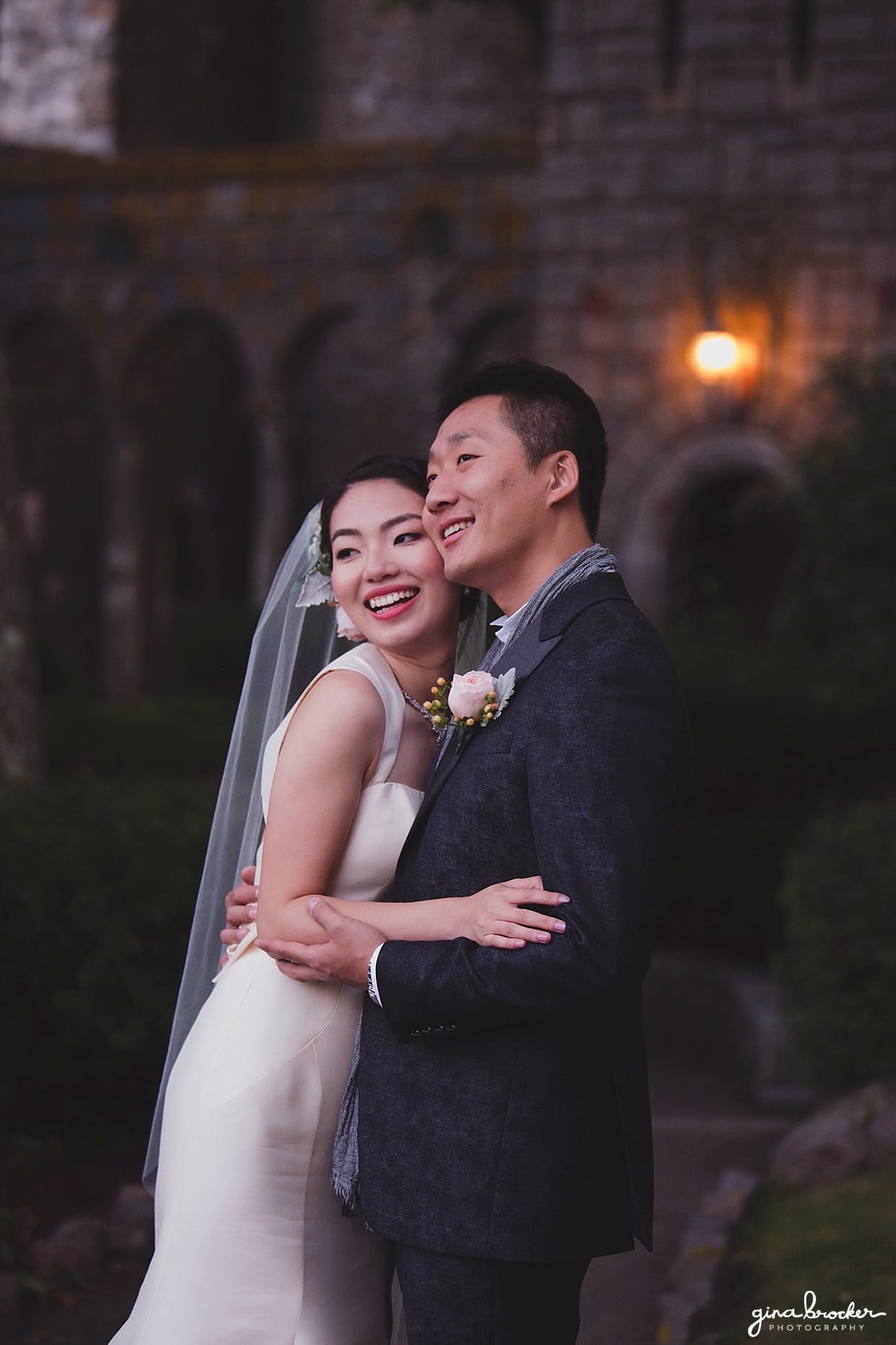 A sweet sunset portrait of a couple wearing an Amsale wedding dress and John Varvatos suit during their Hammond Castle wedding in Gloucester, Massachusetts