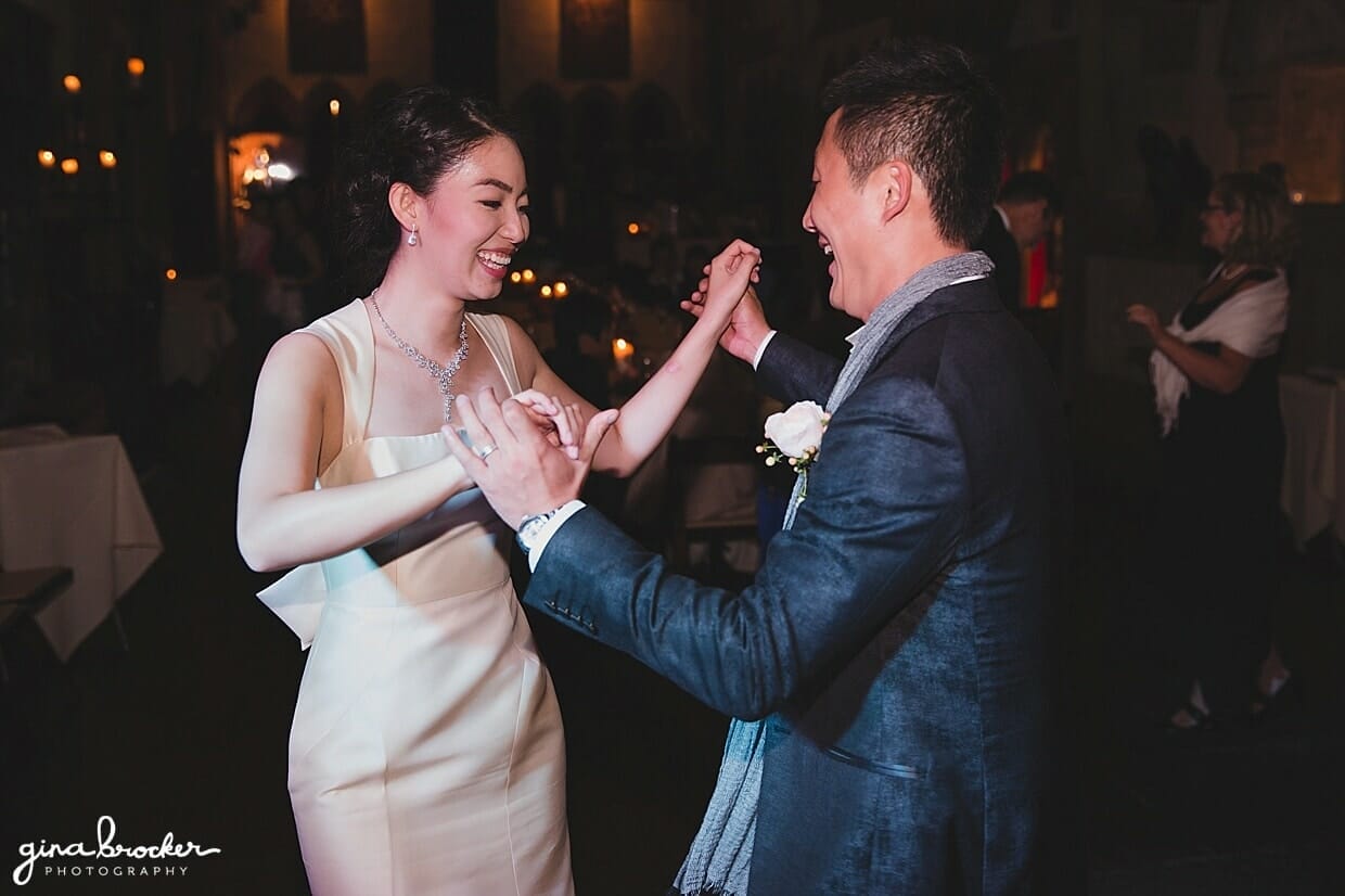 A fun photograph of a bride and groom dancing at their Hammond Castle Wedding in Gloucester, Massachusetts