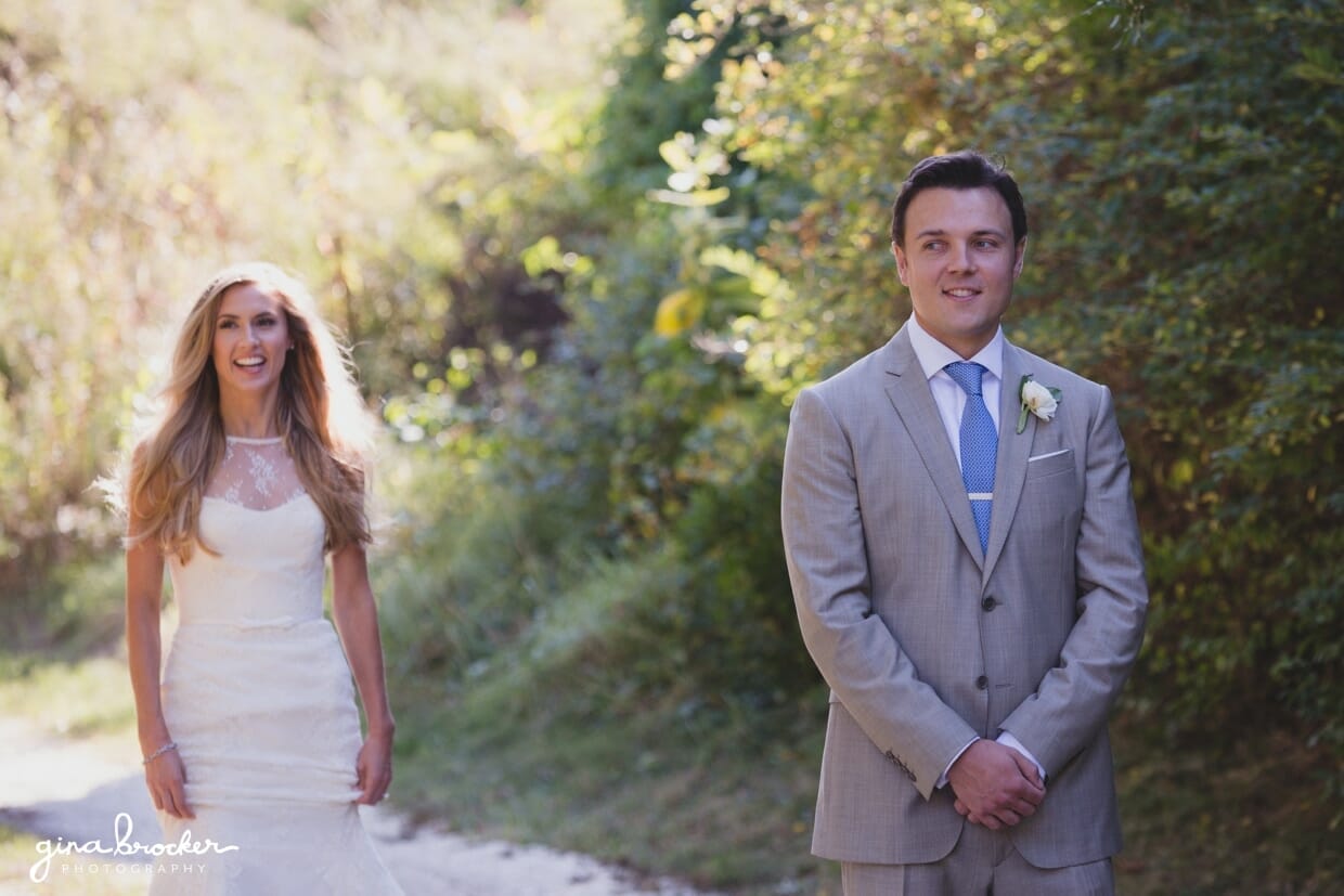 The bride smiles as she walks over to her groom during their first look at the Westmoor Club before their Nantucket wedding