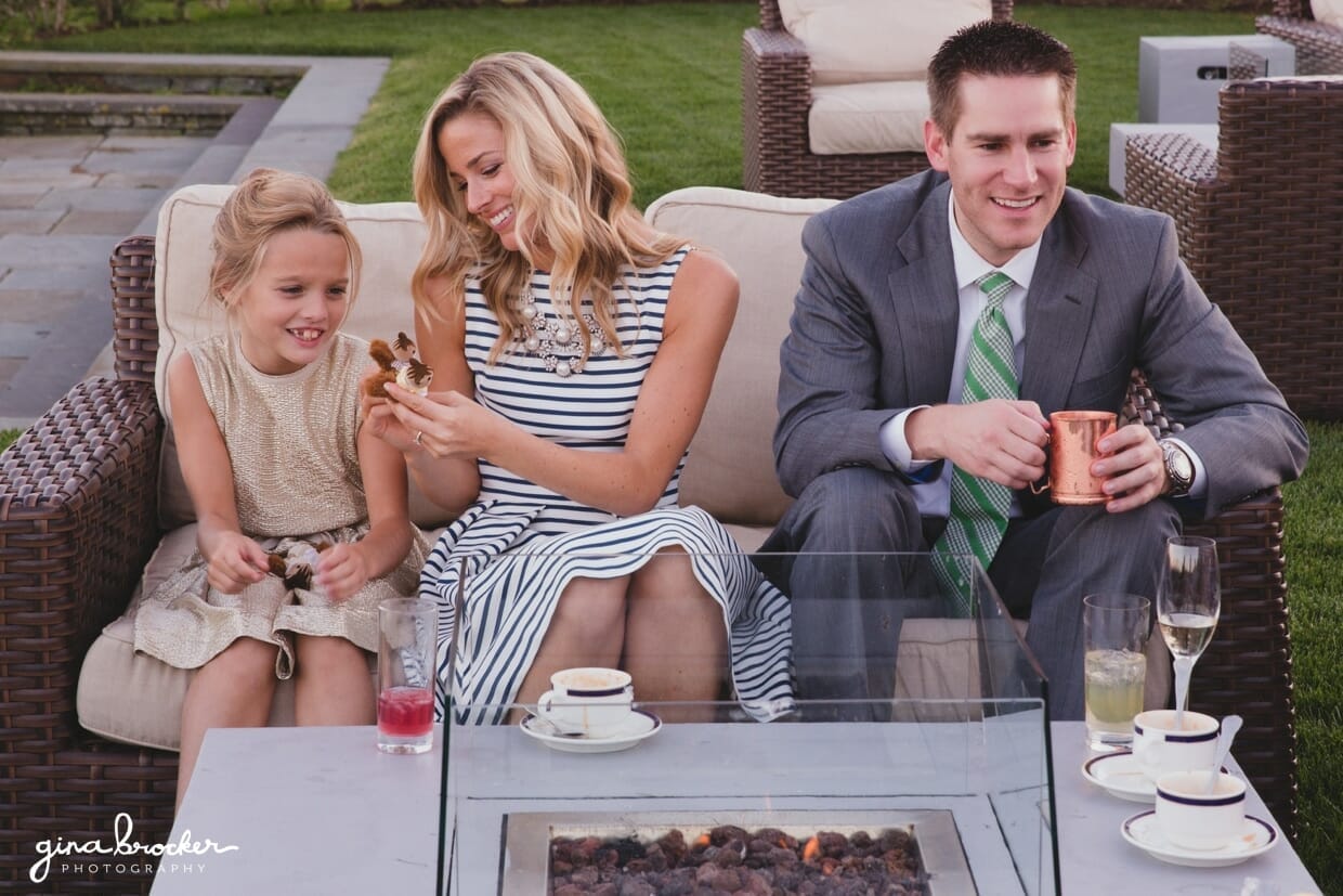 A candid photograph of guests talking and laughing during the cocktail hour of a Nantucket Wedding at the Westmoor Club