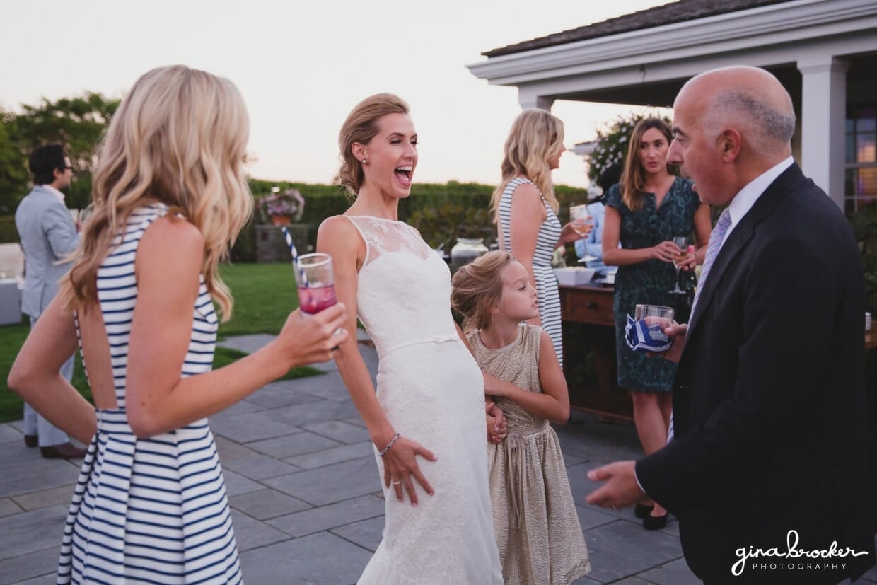 A candid photograph of a bride laughing with her guests during the cocktail hour of her Nantucket Wedding at the Westmoor Club