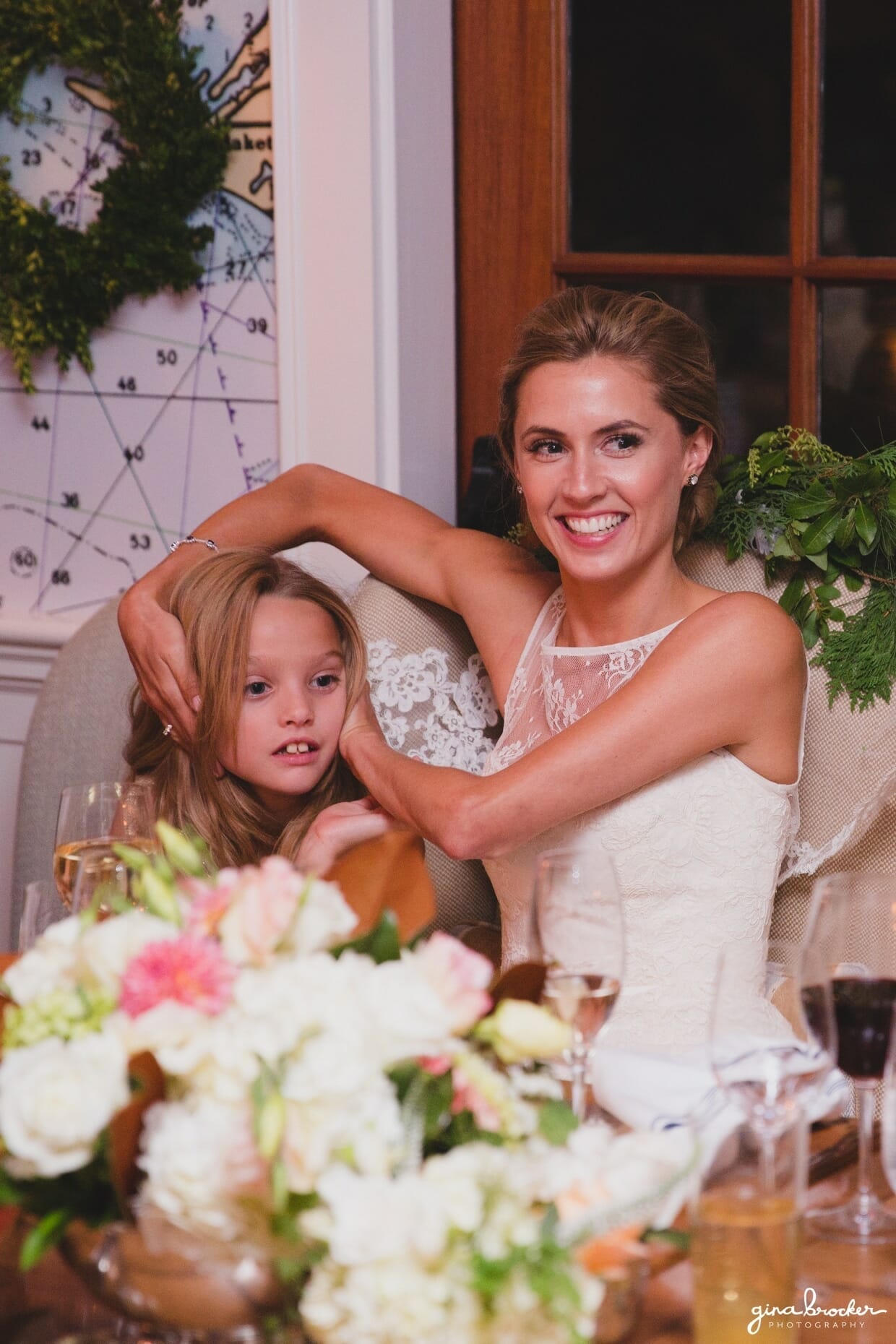 The bride covers the flower girls ears during the wedding toast at the Westmoor Club in Nantucket, Massachusetts