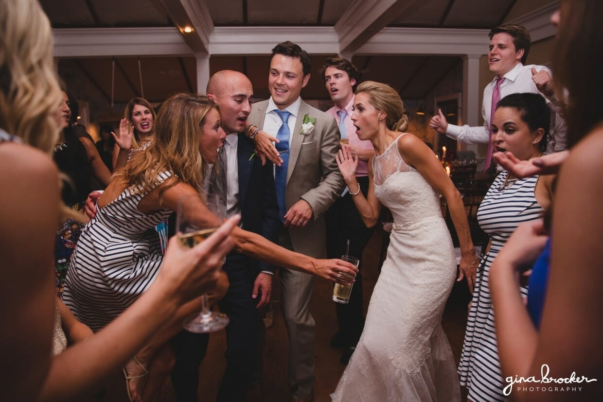 A fun photograph of the bride and groom dancing with the wedding party during their Nantucket Wedding at the Westmoor Club