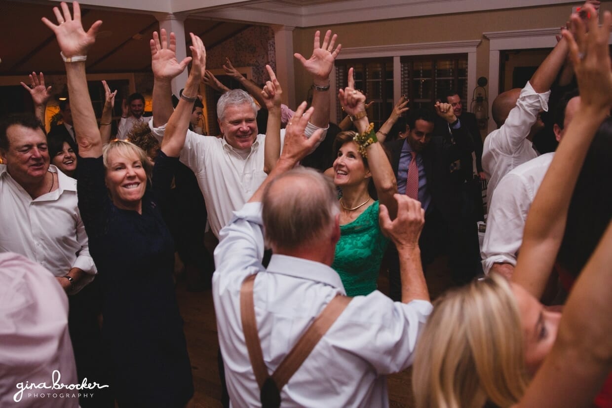 A fun photograph of the guest dancing with their hands in the air during a terrific Nantucket Wedding reception at the Westmoor Club
