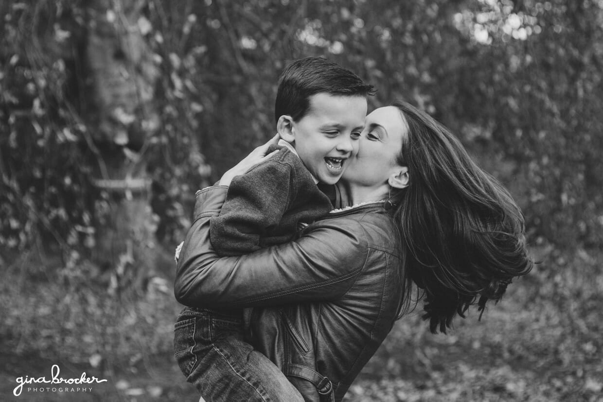 A beautiful and natural photograph that captures a mother playing with son in a park in Boston, Massachusetts