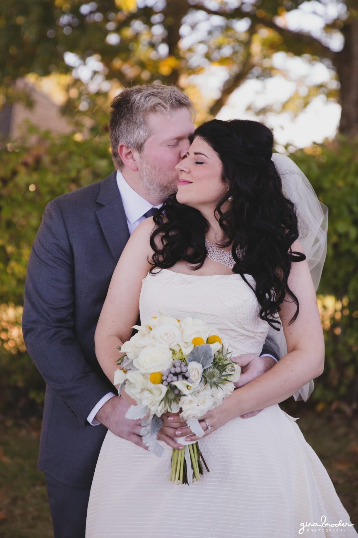 A sweet portrait of a groom kissing his bride's cheek during their oxford farm wedding in Massachusetts