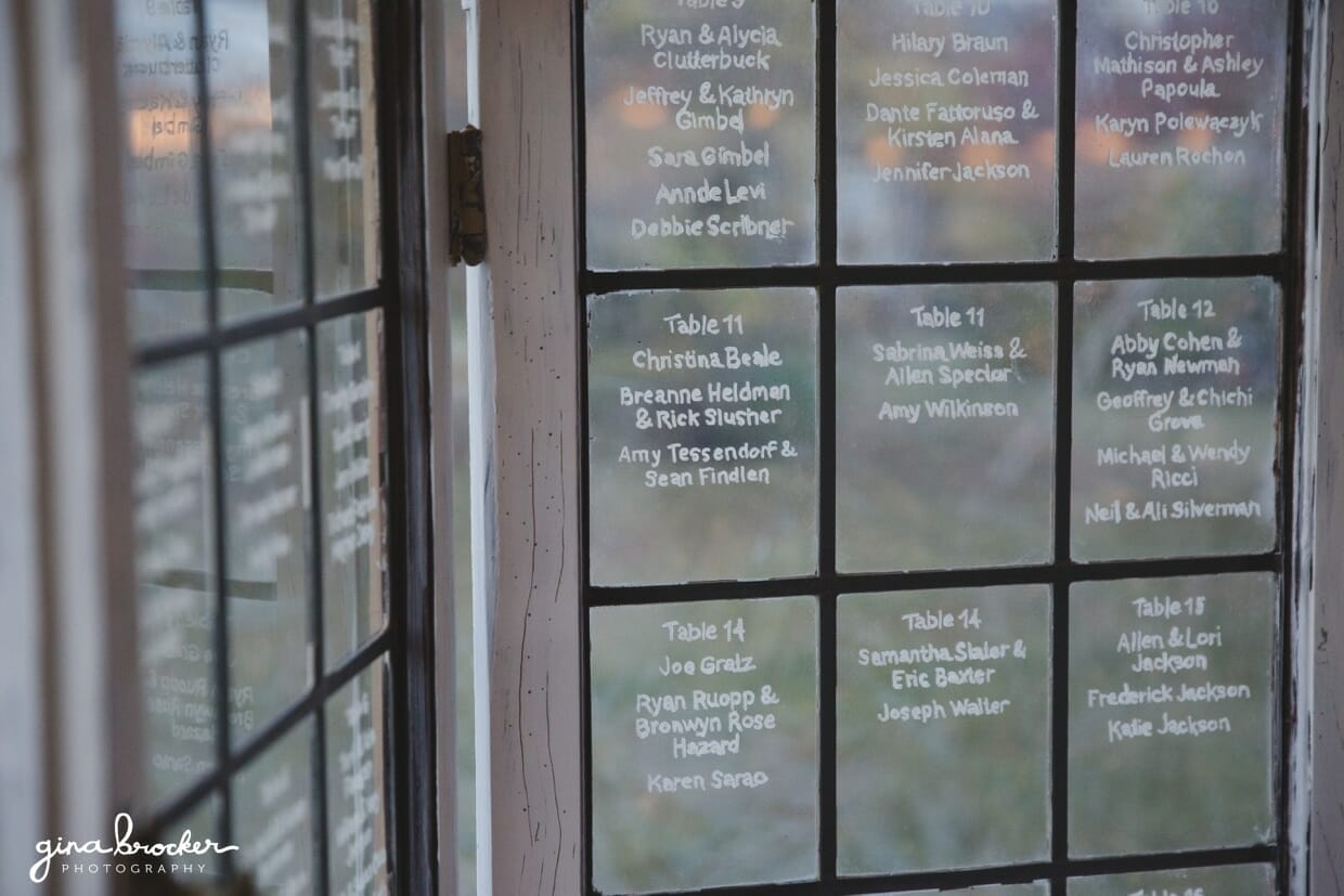 An antique pane of glass is used as beautiful table plan during an Oxford farm wedding in Massachusetts