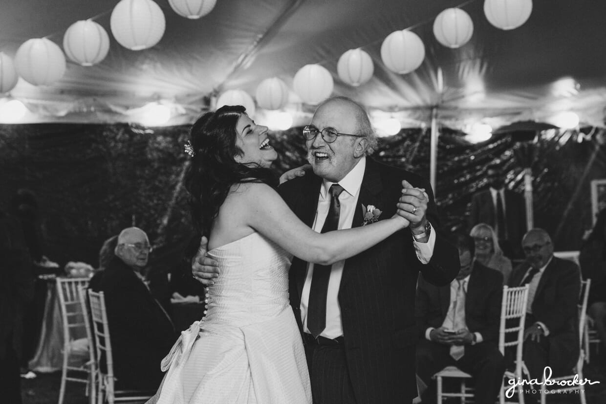 The bride and her father laugh during the father daughter dance at an Oxford farm wedding in Massachusetts