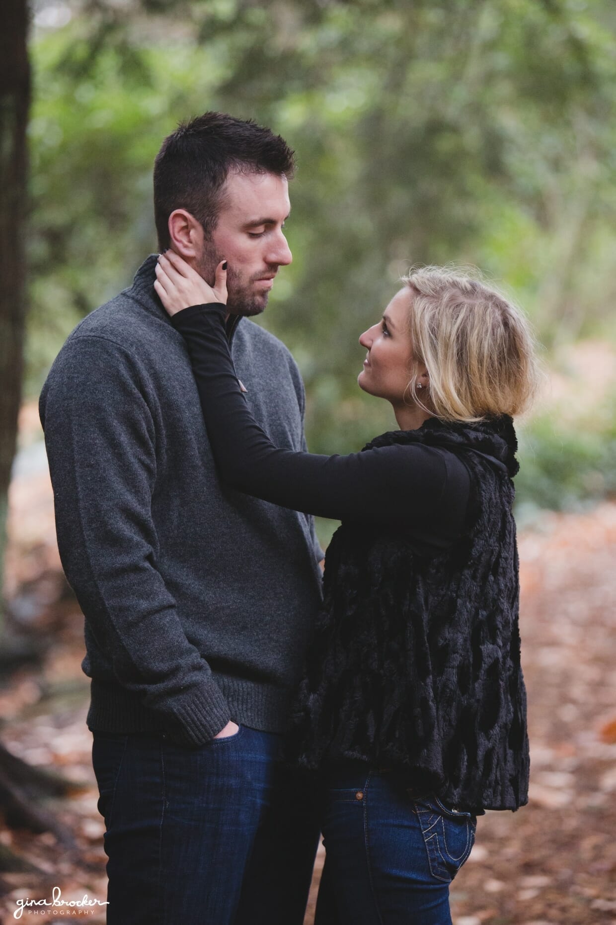 A sweet photograph of a couple in the woods during their fall couple session in Boston's Arnold Arboretum