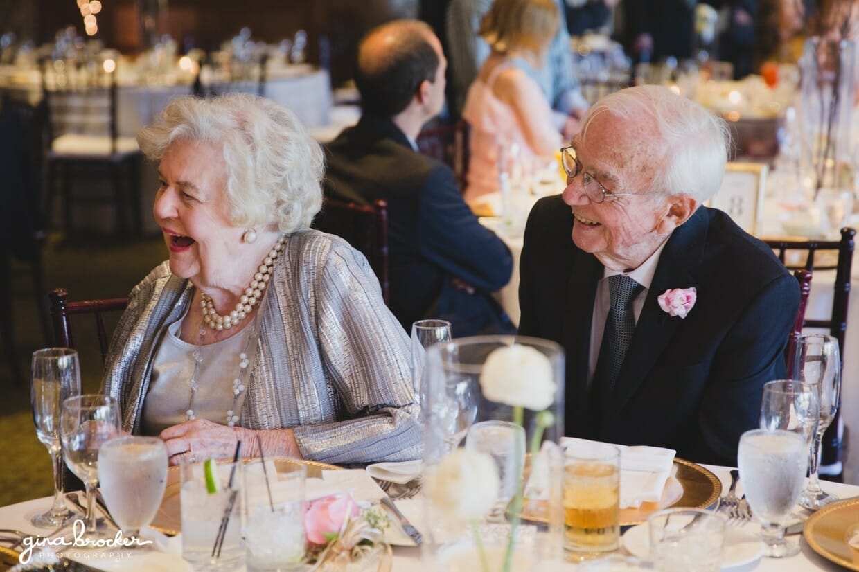Candid photograph of grandparents laughing at a classic and elegant Boston Wedding Reception