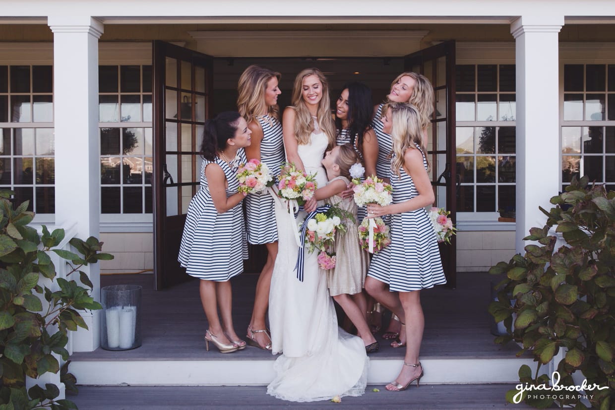 A casual and sweet group photograph of a bride with her bridesmaids wearing nautical inspired dresses