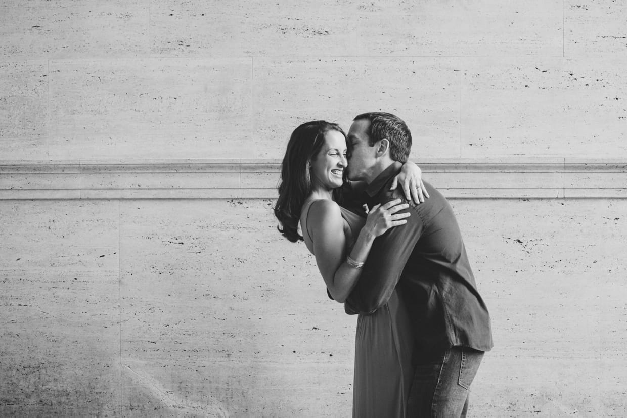 A natural photograph of couple hugging and kissing during their couple session at MIT.